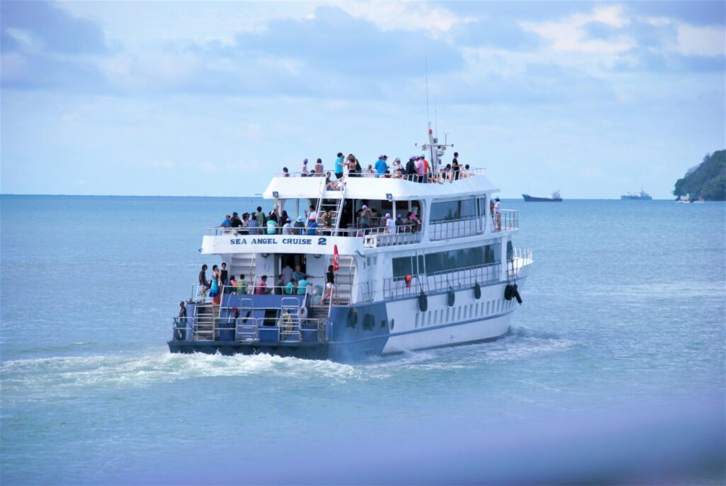 Tourists enjoy a sea cruise on the Sea Angel off the coast of Phuket, Thailand.